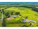 Wide aerial view shows the house with land and various buildings on the property at 500 Coleman Mill Rd, Carrollton, GA 30116