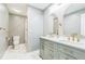 Inviting bathroom featuring a dual sink vanity with gold accents and a tiled shower area at 500 Coleman Mill Rd, Carrollton, GA 30116