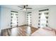 Bright bedroom with three windows dressed in stylish striped curtains and attractive flooring at 500 Coleman Mill Rd, Carrollton, GA 30116