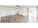 Spacious primary bedroom with wood floors, modern ceiling fan, and sliding glass doors to the backyard at 500 Coleman Mill Rd, Carrollton, GA 30116