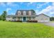 Charming home featuring a large porch, well-manicured lawn, and a three-car garage at 500 Coleman Mill Rd, Carrollton, GA 30116