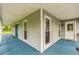 Spacious covered porch featuring painted wood flooring and multiple entry doors at 500 Coleman Mill Rd, Carrollton, GA 30116