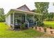 Charming front porch featuring a seating area, decorative accents, and beautiful landscaping creating a welcoming entrance at 500 Coleman Mill Rd, Carrollton, GA 30116