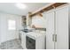 Well-lit laundry room with modern appliances, ample storage, and a stylish black-and-white patterned floor at 500 Coleman Mill Rd, Carrollton, GA 30116