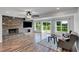 Bright living room featuring a stone fireplace and large windows offering a view of the green outdoors at 500 Coleman Mill Rd, Carrollton, GA 30116