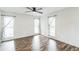 Sunlit living room featuring shiplap walls, beautiful wood floors, and three windows at 500 Coleman Mill Rd, Carrollton, GA 30116
