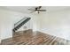 Open living room with hardwood floors, shiplap walls, and stairway access at 500 Coleman Mill Rd, Carrollton, GA 30116