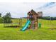 Backyard playground area with swings, slide, climbing wall, and trampoline at 500 Coleman Mill Rd, Carrollton, GA 30116