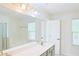 Bathroom features dual sinks, tub, and a separate glass enclosed shower at 3761 Lake Point Blvd, Suwanee, GA 30024