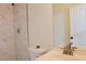 Bright bathroom featuring shower with marble tile, toilet, sink and mirror at 3761 Lake Point Blvd, Suwanee, GA 30024