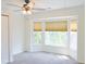 Bedroom featuring a large bay window, blinds, ceiling fan, and closet at 3761 Lake Point Blvd, Suwanee, GA 30024