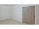Neutral bedroom featuring hardwood floor and closet with decorative sliding barn doors at 3761 Lake Point Blvd, Suwanee, GA 30024