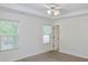 Bright bedroom features crown molding, a ceiling fan, and view from the window at 3761 Lake Point Blvd, Suwanee, GA 30024
