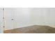 A bedroom featuring neutral carpet and white walls at 3761 Lake Point Blvd, Suwanee, GA 30024