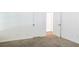 A bedroom featuring neutral carpet and white walls with an open closet at 3761 Lake Point Blvd, Suwanee, GA 30024