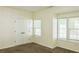 This bedroom features neutral carpeting, built-in closet, and a sunny window at 3761 Lake Point Blvd, Suwanee, GA 30024