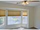 Bedroom featuring a large bay window, blinds, and ceiling fan at 3761 Lake Point Blvd, Suwanee, GA 30024