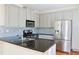 A kitchen featuring stainless steel appliances, grey cabinets, and a dark countertop at 3761 Lake Point Blvd, Suwanee, GA 30024
