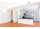 Bright kitchen featuring stainless steel appliances, grey cabinets, and a breakfast bar with black countertops at 3761 Lake Point Blvd, Suwanee, GA 30024