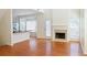 Bright living room boasts hardwood floors, a cozy fireplace, and seamless access to a modern kitchen at 3761 Lake Point Blvd, Suwanee, GA 30024