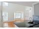 Bright living room with high ceilings and large windows, with an open floorplan to the kitchen at 3761 Lake Point Blvd, Suwanee, GA 30024