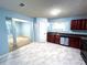 Bright kitchen with marble tile, stainless steel appliances, and cherry wood cabinets at 8838 Seneca Rd, Palmetto, GA 30268
