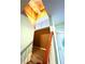 Bright stairwell with light blue walls, natural light, and a wood handrail at 8838 Seneca Rd, Palmetto, GA 30268