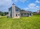 Large, open backyard featuring a well-kept lawn, patio, and lots of space for outdoor activities at 2226 Exchange Se Pl, Conyers, GA 30013