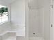 Bright bathroom featuring a soaking tub, a shower, and natural light at 2226 Exchange Se Pl, Conyers, GA 30013