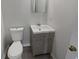Compact bathroom featuring a modern vanity, toilet, and a neutral color scheme at 2226 Exchange Se Pl, Conyers, GA 30013