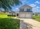 Charming two-story home with a well-maintained front lawn, two-car garage, and manicured bushes at 2226 Exchange Se Pl, Conyers, GA 30013