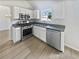 Charming kitchen with stainless steel appliances, bright lighting, and gray countertops at 2226 Exchange Se Pl, Conyers, GA 30013