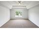 Spacious main bedroom with tray ceilings, neutral carpet and large windows at 2226 Exchange Se Pl, Conyers, GA 30013