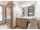 Bathroom features a vanity with a mirror, wood cabinets, a toilet, and a floral curtain at 730 Ponderosa Ct, Fayetteville, GA 30214