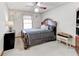 Relaxing bedroom boasts traditional decor, a ceiling fan, and a comfortable, inviting bed at 730 Ponderosa Ct, Fayetteville, GA 30214