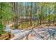 Charming single-story home featuring a wooded lot, curved driveway, and inviting front porch at 730 Ponderosa Ct, Fayetteville, GA 30214