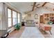 Bright living room featuring hardwood floors, vaulted ceilings, a ceiling fan, and large windows at 730 Ponderosa Ct, Fayetteville, GA 30214