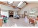 Bright living room featuring a brick fireplace, hardwood floors, skylights, and comfortable seating at 730 Ponderosa Ct, Fayetteville, GA 30214