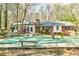 Backyard featuring a pool with a cover, surrounded by a deck, plants, and various seating at 730 Ponderosa Ct, Fayetteville, GA 30214