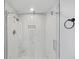 Modern bathroom with frameless glass shower door, white marble tiling, and bronze hardware at 1 Lamar Ave Sw, Atlanta, GA 30310