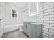 Stylishly updated bathroom featuring a new vanity, modern light fixtures, and tile flooring at 1 Lamar Ave Sw, Atlanta, GA 30310