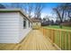 New backyard wooden deck overlooking the green lawn and mature trees behind the property at 1 Lamar Ave Sw, Atlanta, GA 30310