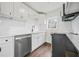 This modern kitchen features all white cabinets, backsplash, countertops and new appliances at 1 Lamar Ave Sw, Atlanta, GA 30310