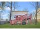 Backyard view of a home with a tiered wooden deck, grassy lawn, and privacy fence at 1995 Meador Ave, Atlanta, GA 30315