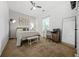 The bedroom includes a bed with soft bedding, a ceiling fan, a desk with chair and a wooden bench at 1995 Meador Ave, Atlanta, GA 30315