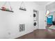 Hallway with stacked washer and dryer, shelving, and entry to the living room at 1995 Meador Ave, Atlanta, GA 30315