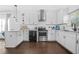 Bright white kitchen featuring stainless steel appliances, subway tile backsplash, and dark hardwood floors at 1995 Meador Ave, Atlanta, GA 30315