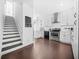 Bright kitchen with stainless steel appliances, white cabinets, and hardwood floors near the staircase at 1995 Meador Ave, Atlanta, GA 30315