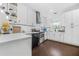 Well-lit kitchen with white cabinetry, stainless steel appliances, light countertops, and dark hardwood floors at 1995 Meador Ave, Atlanta, GA 30315