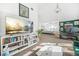 Open-concept living area with bookshelves, a large TV, and a view into the primary bedroom at 1995 Meador Ave, Atlanta, GA 30315